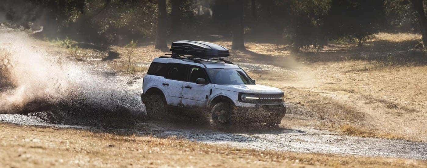 White 2025 Ford Bronco Sport kicking up mud off-road