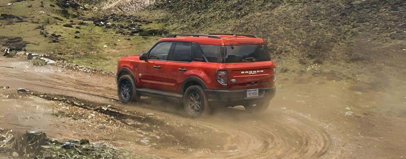 A red 2023 Ford Bronco Sport Big Bend off-roading on a dirt trail