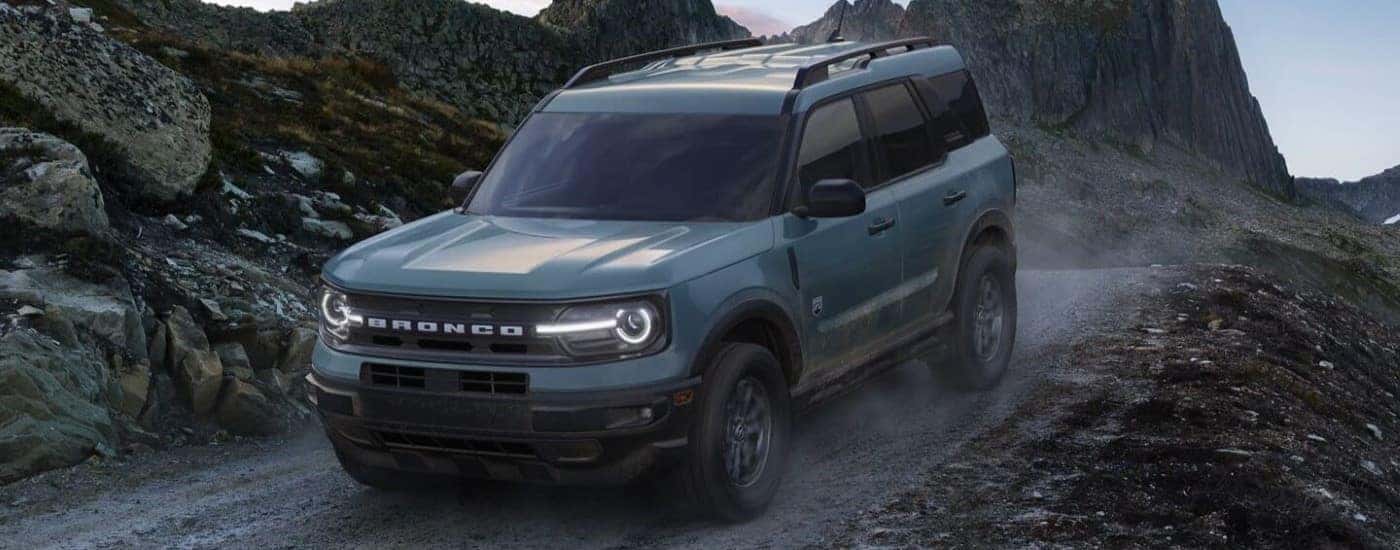 A blue 2024 Ford Bronco Sport Big Bend off-roading on a trail