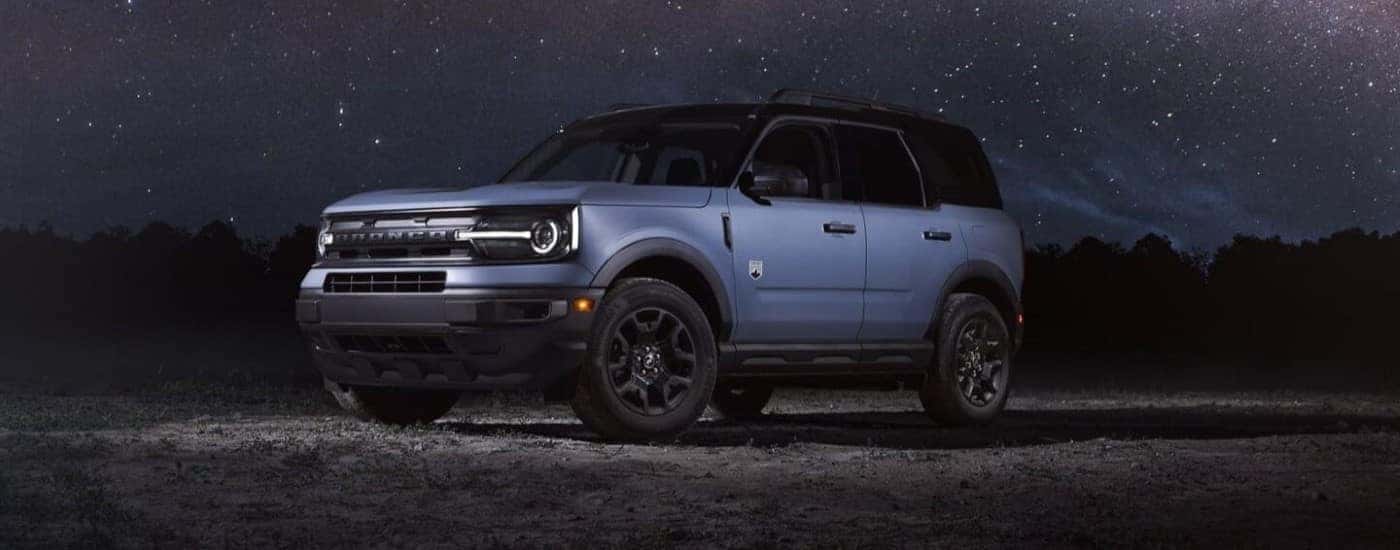 A blue 2024 Ford Bronco Sport parked under a starry sky