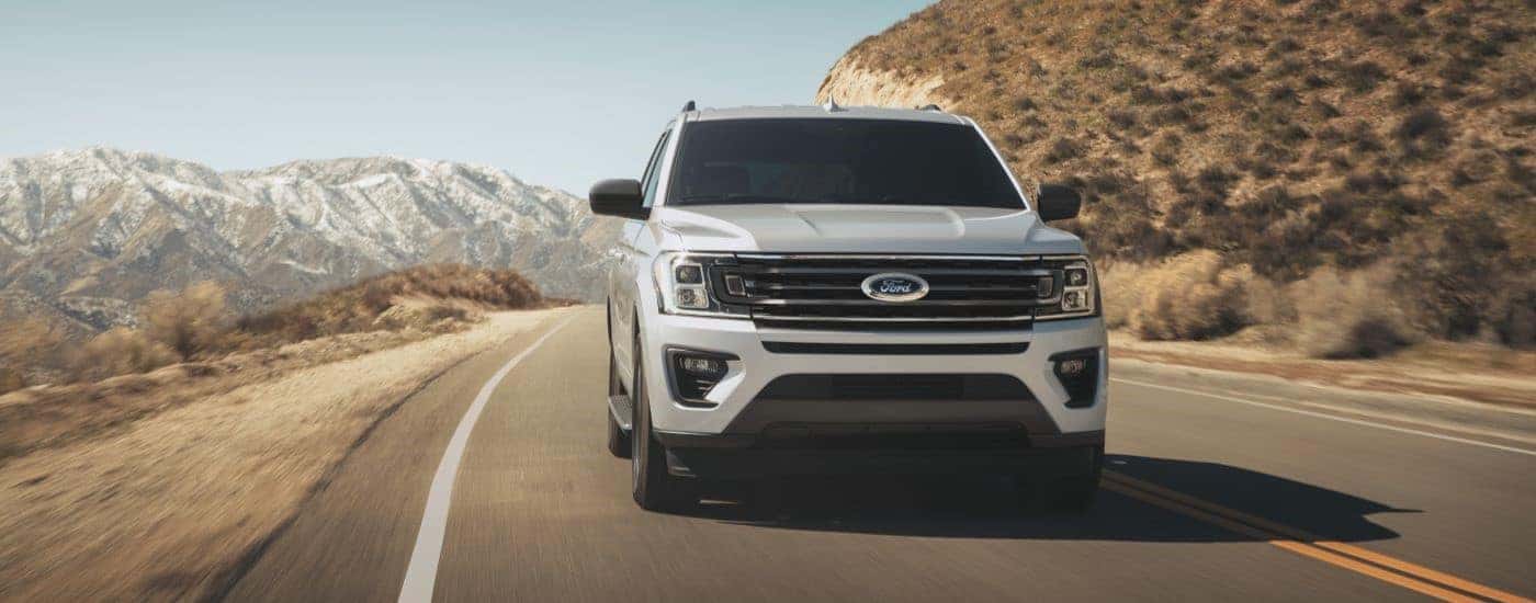 White 2022 Ford Expedition driving to see a used Ford for sale in Saint Johns
