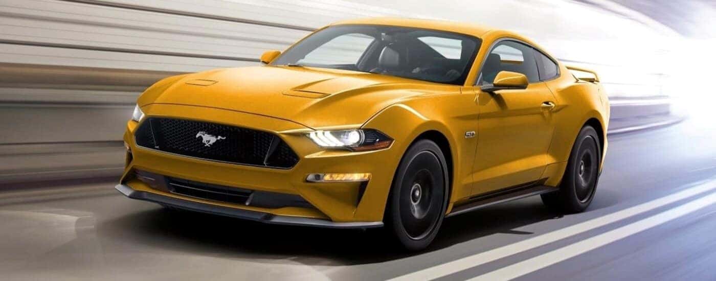 A yellow 2022 Ford Mustang GT from the front.