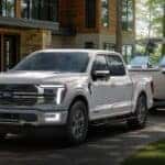White 2026 Ford F-150 parked near a cabin