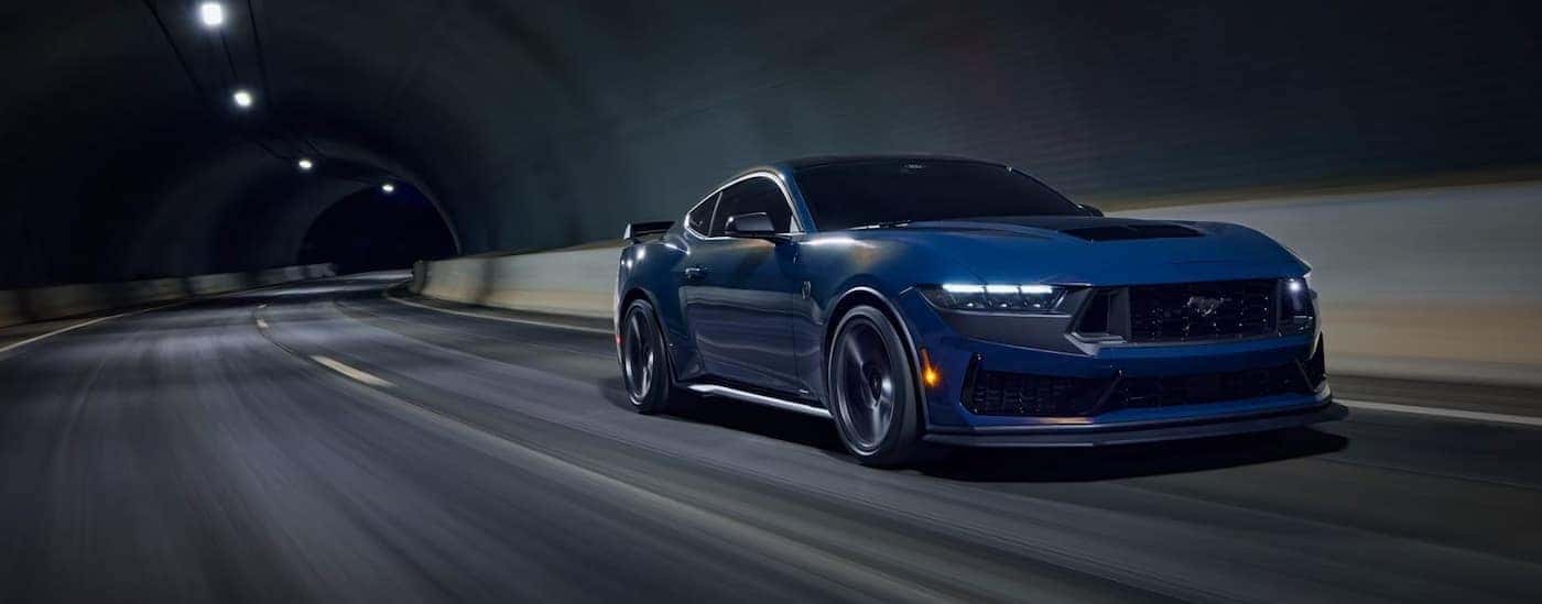 A blue 2026 Ford Mustang driving in a tunnel.