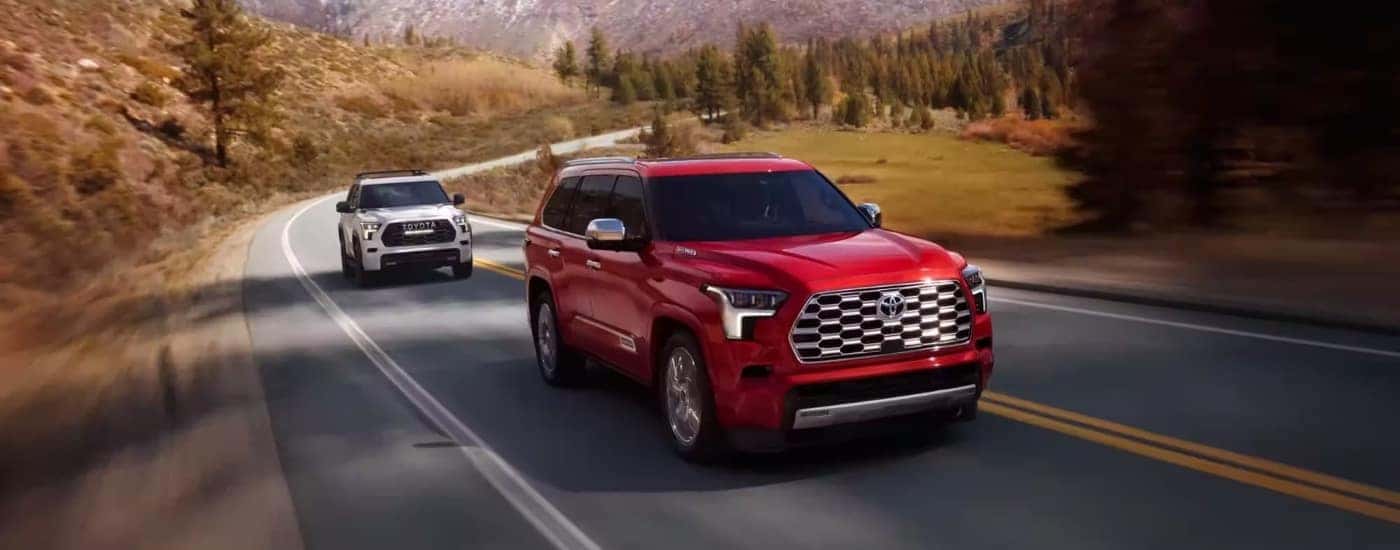 Red 2024 Toyota Sequoia TRD Pro with a white one following