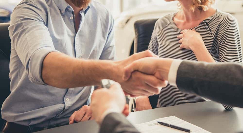 Customer and salesman shaking hands after a successful deal