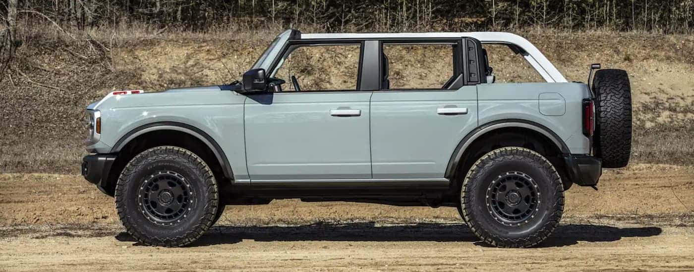 Side view of a powder blue 2021 Ford Bronco parked off-road