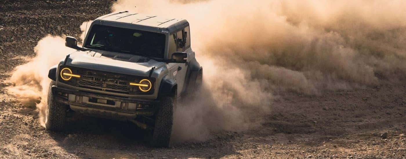 A gray 2025 Ford Bronco Raptor off-roading in sand