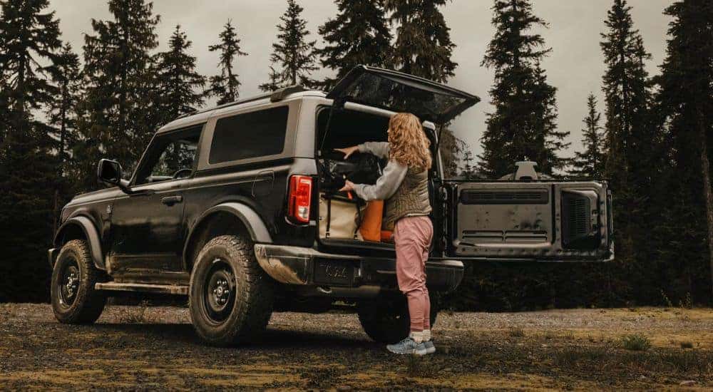 Black2026 Ford Bronco with a woman loading the trunk