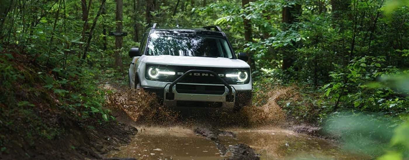 White 2026 Ford Bronco Sport driving though mud