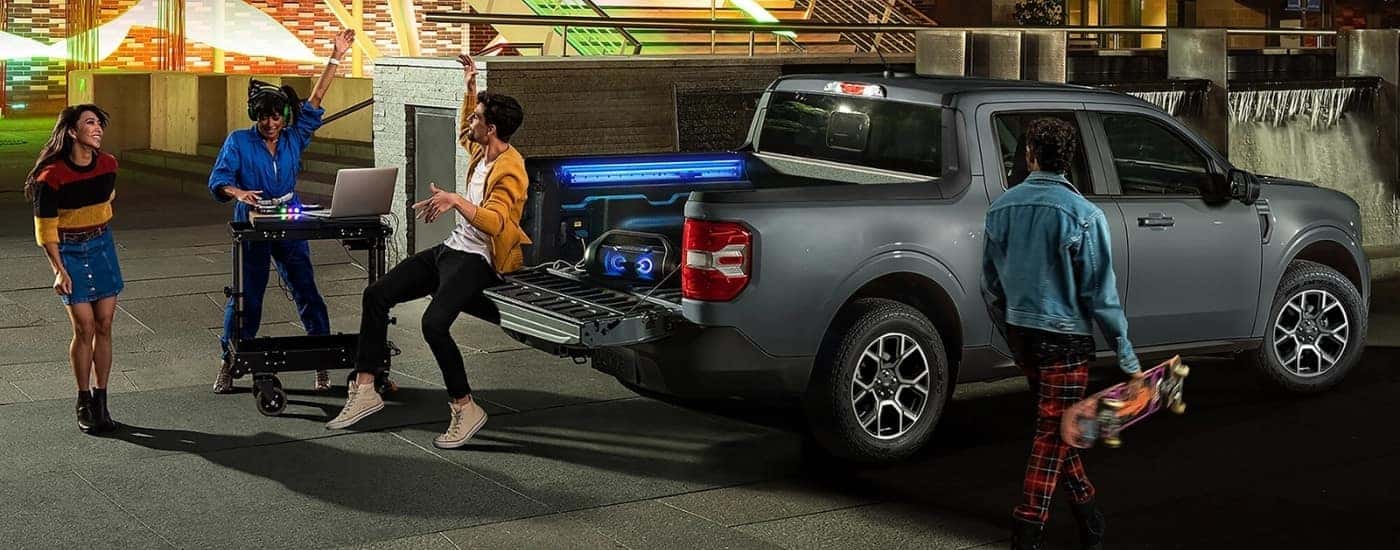 People partying near a grey 2025 Ford Maverick Lariat