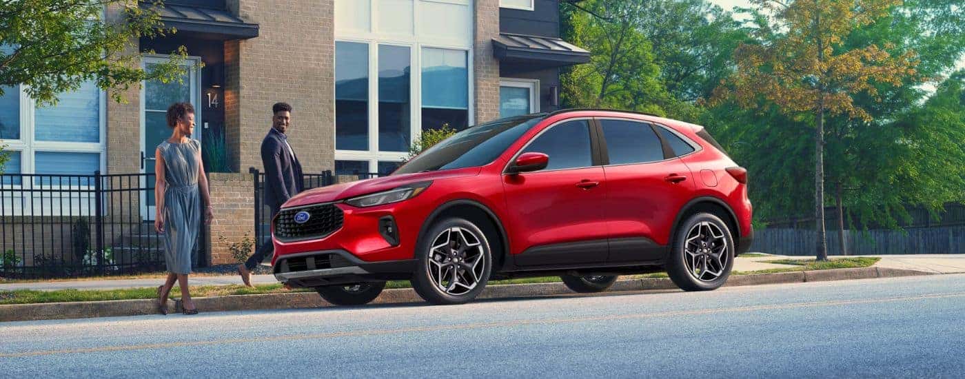 Red 2026 Ford Escape parked in front of an apartment building.