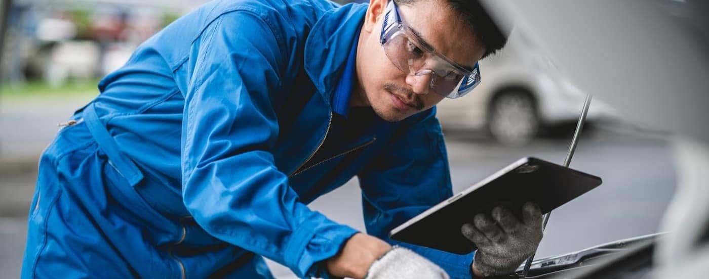 A technician inspecting an egine.