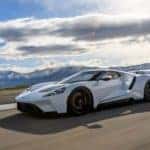 A white 2017 Ford GT is shown on a track on a cloudy day.