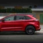 A red 2021 Ford Edge is shown from the side.