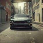 A green 2020 Ford Mustang BULLITT is shown parked in an alleyway.