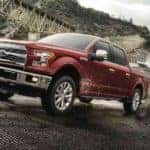 A red 2017 Ford F-150 is shown towing a boat.