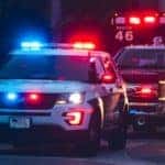 Emergency vehicles are shown parked on a street.