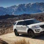 A white 2017 Ford Explorer is shown parked in the mountains.