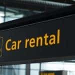 A car rental sign is shown.