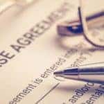 A pen is shown on top of a lease agreement.