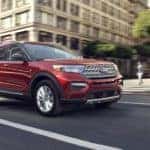 A red 2020 Ford Explorer is shown on a city street.