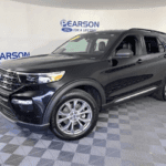 A black 2021 used Ford Explorer is shown parked in a showroom.