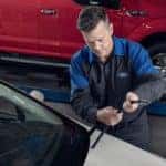 A Ford technician is shown replacing a wiper blade.