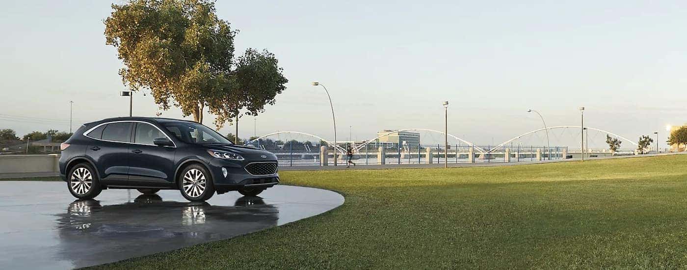 A black 2022 Ford Escape Titanium Hybrid is shown parked in an empty lot.