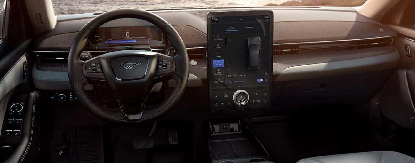 The interior of a 2022 Ford Mustang Mach-E shows the steering wheel and infotainment screen.