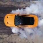 A yellow 2017 Ford Mustang Ecoboost is shown from above after leaving a used car dealership near you.
