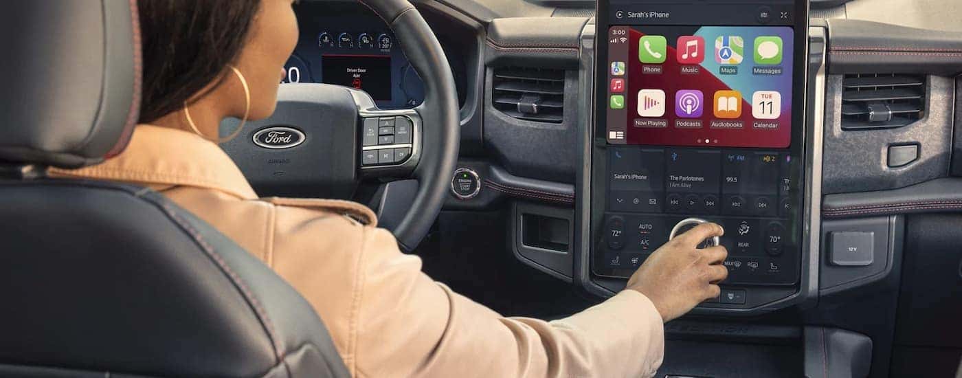 A woman is shown using the infotainment screen in a 2023 Ford Expedition.