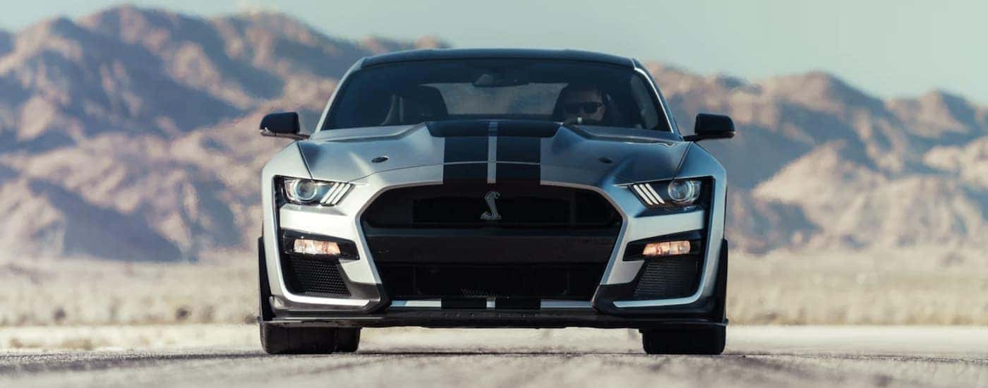 A silver 2022 Ford Mustang GT500 parked on a runway.