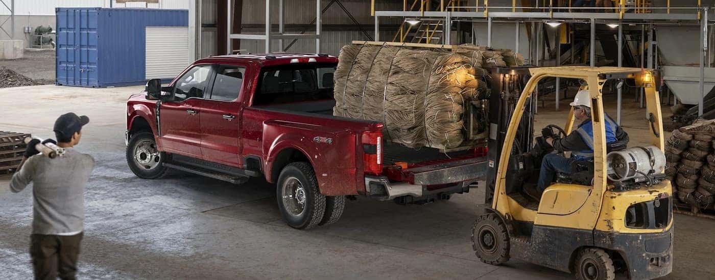 A red 2023 Ford F-450 in a warehouse.