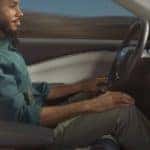 A person is shown using the Blue Cruise feature in a 2023 Ford Mustang Mach-E.