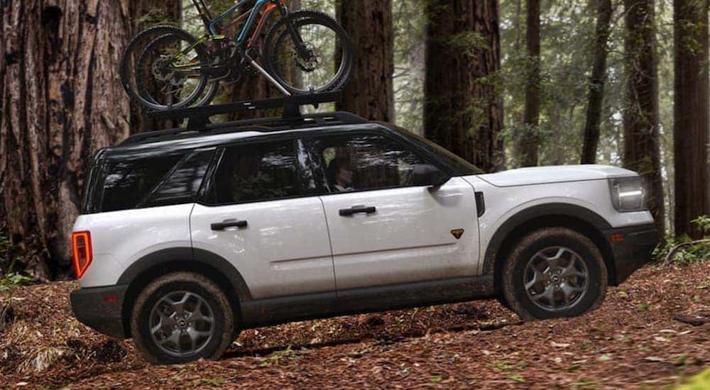 A white 2023 Ford Bronco Badlands is shown from the side.