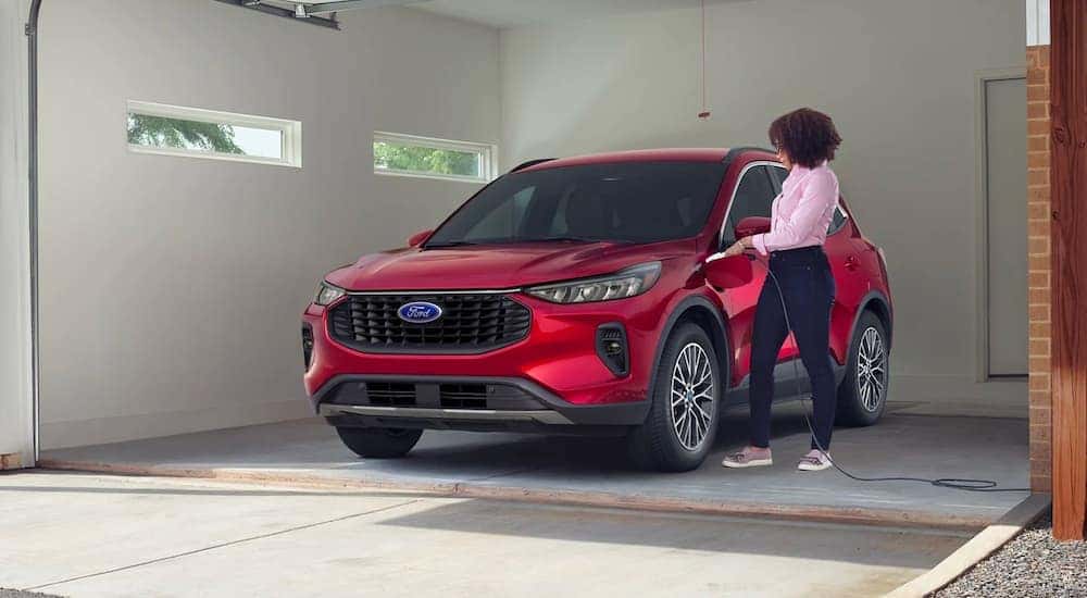 A red 2023 Ford Escape Hybrid is shown parked in a garage.