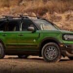 A green 2023 Ford Bronco Sport Outer Banks is shown parked off-road after visiting a Ford dealer near Whitestown.