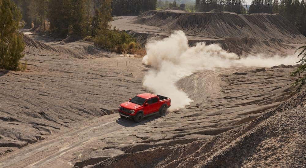 An orange 2024 Ford Ranger Raptor is shown from the front at an angle after leaving a Ford dealer near Brownsburg.