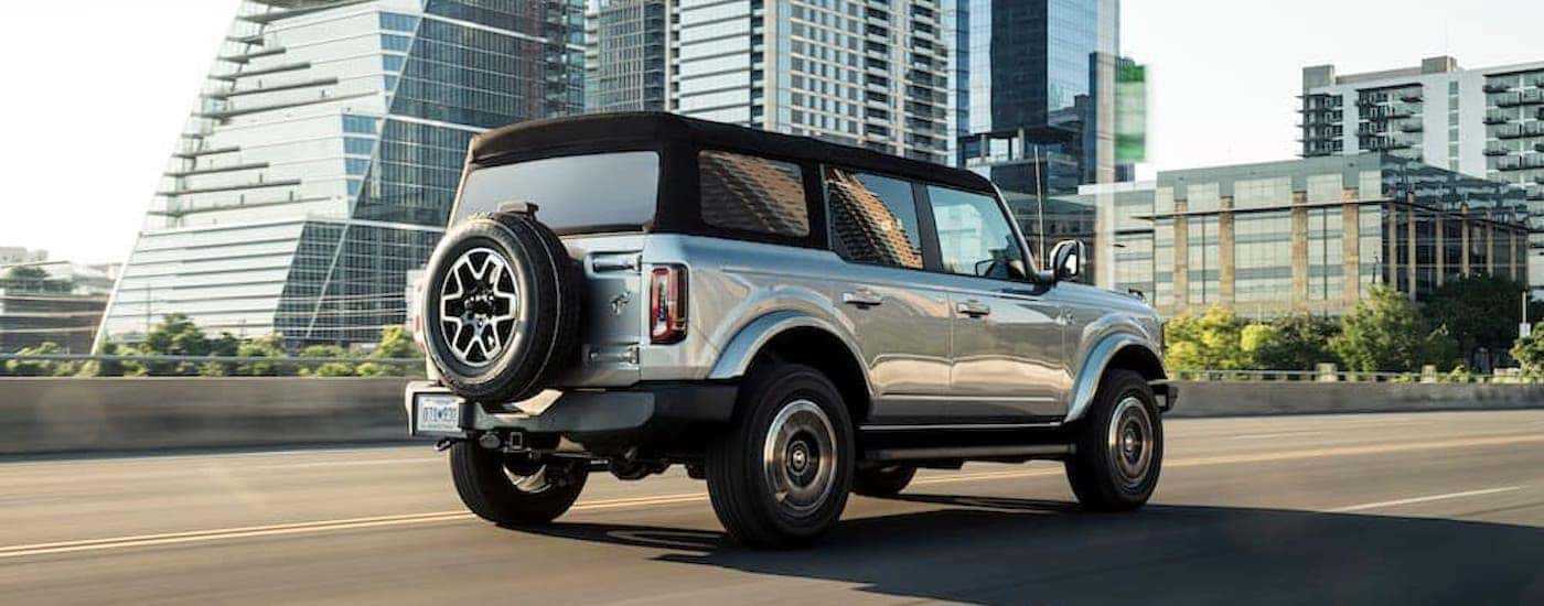 A silver 2021 Ford Bronco Outer Banks is shown from the rear at an angle after leaving a Ford dealer near Fishers.