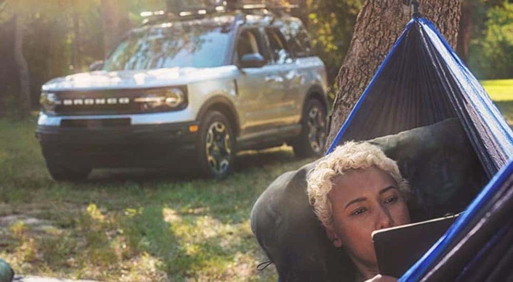 A person is shown in a hammock near a silver 2023 Ford Bronco Sport after leaving a Ford dealer near Noblesville.