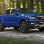 A blue 2019 Ford Ranger FX2 is shown driving on a road after visiting a used car dealership.