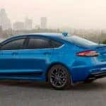 A blue 2020 Ford Fusion is shown parked after visiting a used car dealer near Fishers.