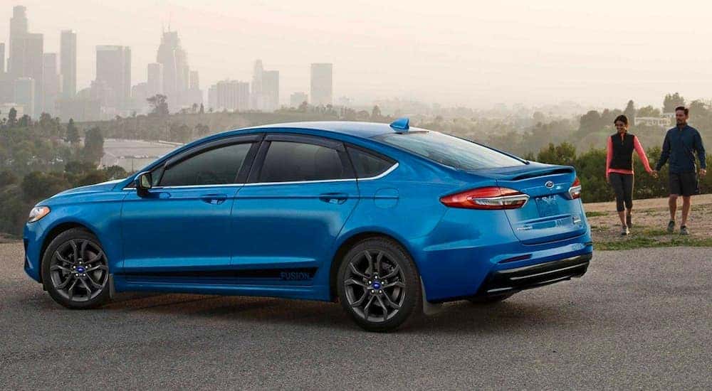 A blue 2020 Ford Fusion is shown parked after visiting a used car dealer near Fishers.