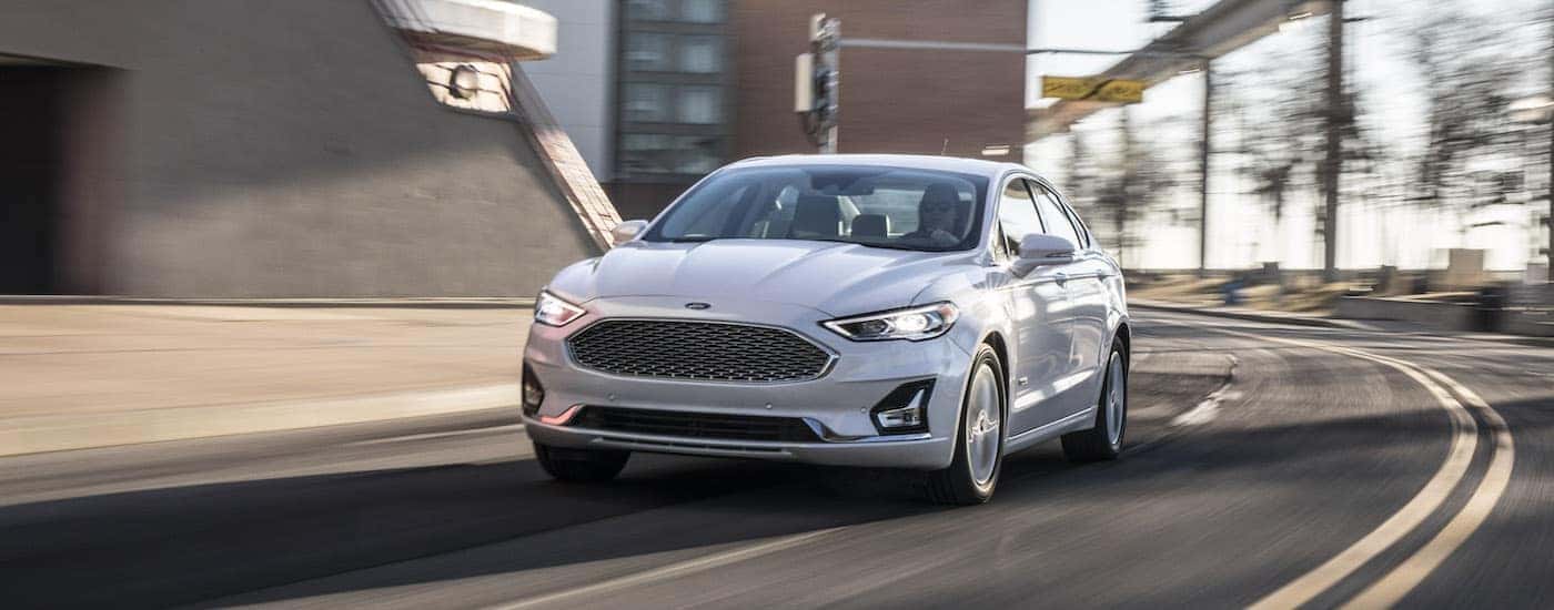 A white 2020 Ford Fusion Hybrid is shown from the front at an angle.