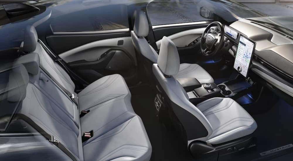 The gray and white interior and dash of a 2024 Ford Mustang Mach-E is shown.
