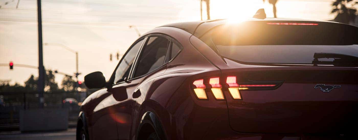 A red 2024 Ford Mustang Mach-E is shown from the rear in close-up.