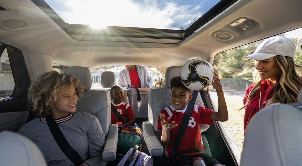 A family is getting ready to leave for a soccer game in the back of a 2025 Ford Explorer.