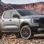 A gray 2024 Ford Ranger Sport is shown parked off-road.