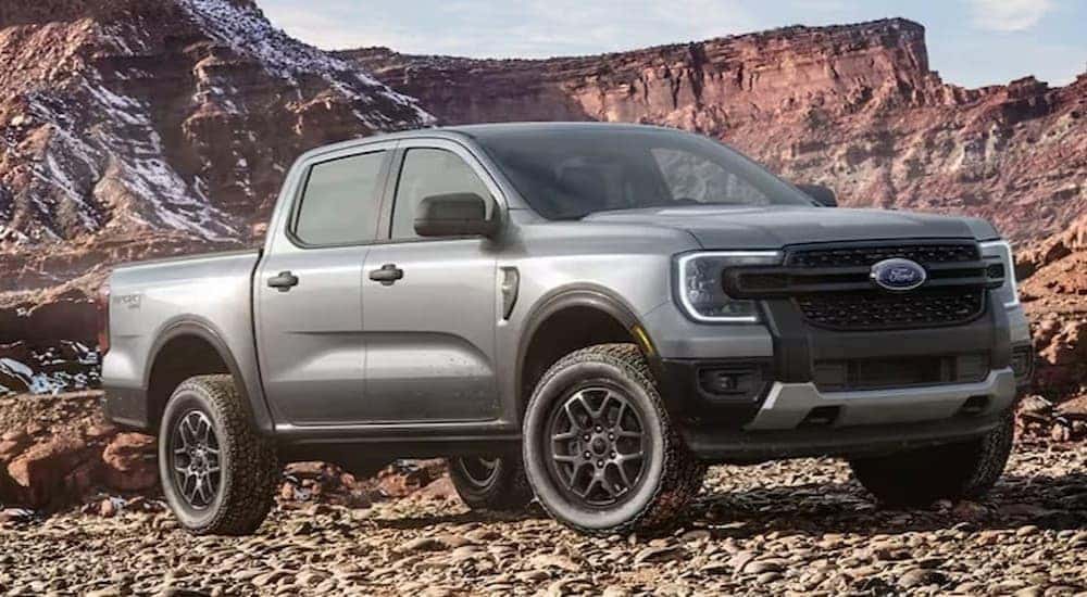 A gray 2024 Ford Ranger Sport is shown parked off-road.